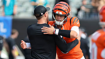 Sep 14, 2025; Cincinnati, Ohio, USA;  Cincinnati Bengals quarterback Joe Burrow (9) greets a coach before the game against the Jacksonville Jaguars at Paycor Stadium. Mandatory Credit: Joseph Maiorana-Imagn Images