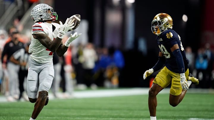 Ohio State Buckeyes wide receiver Jeremiah Smith (4) makes a catch against Notre Dame Fighting Irish cornerback Christian Gray (29) in the fourth quarter during the College Football Playoff National Championship at Mercedes-Benz Stadium in Atlanta on January 20, 2025.