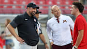 Oct 4, 2025; Columbus, Ohio, USA; Ohio State Buckeyes head coach Ryan Day and Minnesota Golden Gophers head coach P.J. Fleck talk before the game at Ohio Stadium. Mandatory Credit: Joseph Maiorana-Imagn Images