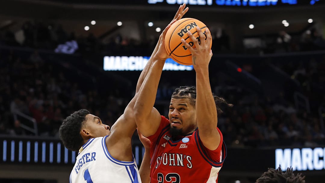 Mar 27, 2026; Washington, DC, USA; St. John's basketball forward Bryce Hopkins (23) attempts to shoot the ball over Duke Blue Devils guard Caleb Foster (1) in the first half during a Sweet Sixteen game of the East Regional of the men's 2026 NCAA Tournament at Capital One Arena. 