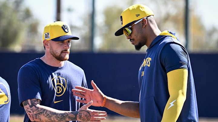 Milwaukee Brewers infielder Brice Turang (2), left, shakes hands with infielder Ernesto Martinez Jr. during spring training workouts Saturday, February 15, 2025, at the American Family Fields of Phoenix in Phoenix, Arizona.