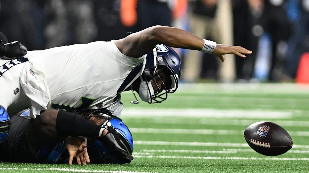 Sep 30, 2024; Detroit, Michigan, USA;  Seattle Seahawks quarterback Geno Smith (7) fumbles the ball after being sacked by Detroit Lions defensive tackle Alim McNeill (54) in the fourth quarter at Ford Field. Mandatory Credit: Lon Horwedel-Imagn Images