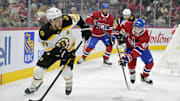 Apr 3, 2025; Montreal, Quebec, CAN; Boston Bruins forward David Pastrnak (88) plays the puck and Montreal Canadiens defenseman Lane Hutson (48) defends during the first period at the Bell Centre. Mandatory Credit: Eric Bolte-Imagn Images
