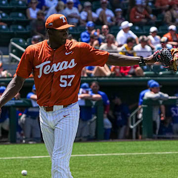 Texas Longhorns pitcher Lebarron Johnson Jr. (57) bumps gloves with infielder Jalin Flores (1) after a catch for a third out during the game against Kansas at UFCU Disch–Falk Field on Saturday, May. 18, 2024 in Austin.