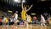 Mar 2, 2025; Ann Arbor, Michigan, USA;  Michigan Wolverines center Danny Wolf (1) loses control of the ball while driving to the basket against Illinois Fighting Illini guard Kylan Boswell (4) in the first half at Crisler Center. Mandatory Credit: Lon Horwedel-Imagn Images
