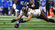 Sep 15, 2024; Detroit, Michigan, USA; Tampa Bay Buccaneers offensive tackle Justin Skule (77) recovers a fumble against the Detroit Lions in the first quarter at Ford Field.