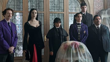 (L to R) Steve Buscemi as Barry Dort, Catherine Zeta-Jones as Morticia Addams, Jenna Ortega as Wednesday Addams, Isaac Ordonez as Pugsley Addams, Joonas Suotamo as Lurch, and Luis Guzmán as Gomez Addams in episode 201 of Wednesday