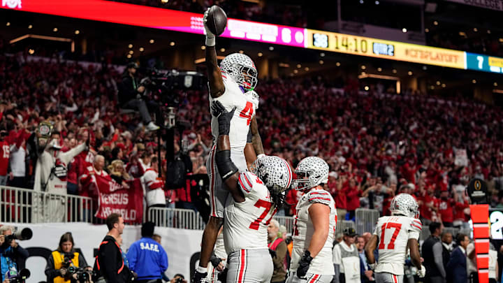 Ohio State Buckeyes wide receiver Jeremiah Smith (4) celebrates with offensive lineman Donovan Jackson (74) after a touchdown catch against Notre Dame Fighting Irish in the first quarter during the College Football Playoff National Championship at Mercedes-Benz Stadium in Atlanta on January 20, 2025.