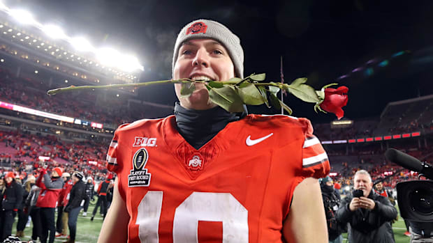 Ohio State Buckeyes quarterback Will Howard (18) celebrates the win as he carries a rose after the game against the Tennessee