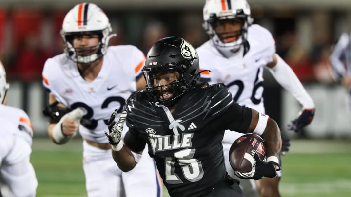 U of L's Jawhar Jordan (25) eludes Virginia defenders during their game at the L&N Stadium in Louisville, Ky. on Nov. 9, 2023.