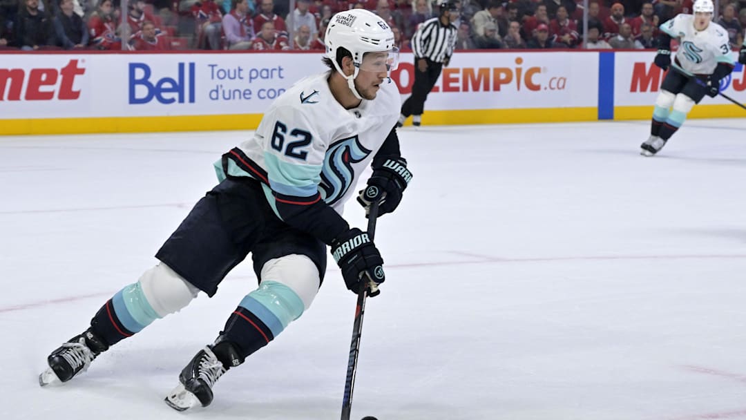Oct 14, 2025; Montreal, Quebec, CAN; Seattle Kraken defenseman Brandon Montour (62) plays the puck against the Montreal Canadiens during the second period at the Bell Centre. Mandatory Credit: Eric Bolte-Imagn Images