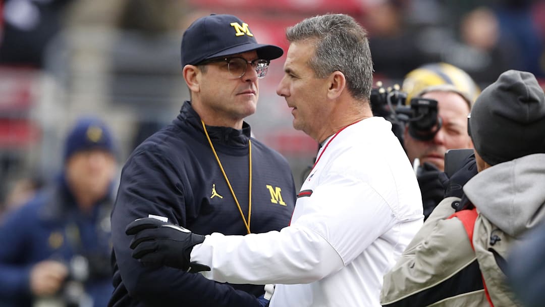 Nov 26, 2016; Columbus, OH, USA;  Michigan Wolverines head coach Jim Harbaugh and Ohio State Buckeyes head coach Urban Meyer shake hands before the game at Ohio Stadium. Mandatory Credit: Joe Maiorana-Imagn Images