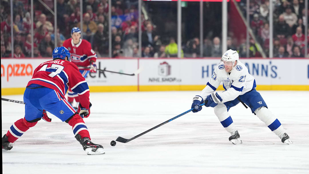 Dec 9, 2025; Montreal, Quebec, CAN;Tampa Bay Lightning forward Brayden Point (21) plays the puck and Montreal Canadiens defenseman Jayden Struble (47) defends during the first period at the Bell Centre. Mandatory Credit: Eric Bolte-Imagn Images