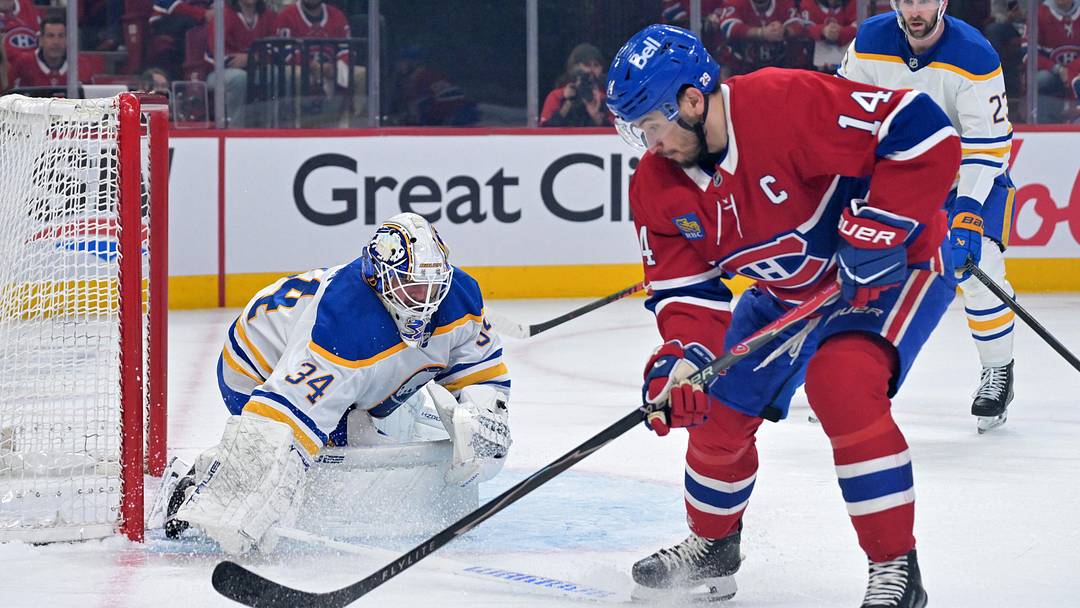 May 10, 2026; Montreal, Quebec, CAN; Buffalo Sabres goalie Alex Lyon (34) stops Montreal Canadiens forward Nick Suzuki (14) during the first period in game three of the second round of the 2026 Stanley Cup Playoffs at the Bell Centre. Mandatory Credit: Eric Bolte-Imagn Images