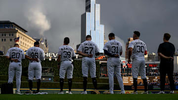 Detroit Tigers players, from left: Spencer Torkelson (20), Wenceel Perez (46), Zach McKinstry (39), Trey Sweeney (27), Riley Greene (31), and Kerry Carpenter (30)  stand at attention for the National Anthem before their game against the Houston Astros at Comerica Park.