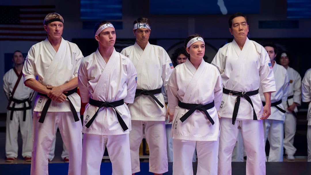 Cobra Kai. (L to R) William Zabka as Johnny Lawrence, Tanner Buchanan as Robby Keene, Ralph Macchio as Daniel LaRusso, Mary Mouser as Samantha LaRusso, Yuji Okumoto as Chozen in Cobra Kai. Cr. Curtis Bonds Baker/Netflix © 2024