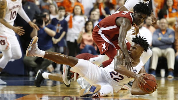 Alabama Crimson Tide guard Kira Lewis, Jr. fights for a loose ball at Auburn in 2000.