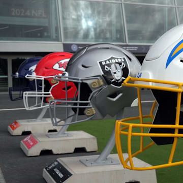 Oct 13, 2024; London, United Kingdom; Large helmets of the Los Angeles Chargers, Las Vegas Raiders, Kansas City Chiefs and Denver Broncos of the AFC West before an NFL International Series game at Tottenham Hotspur Stadium. Mandatory Credit: Kirby Lee-Imagn Images