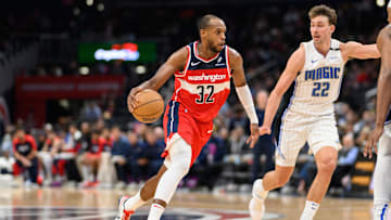 Mar 21, 2025; Washington, District of Columbia, USA; Washington Wizards forward Khris Middleton (32) handles the ball against Orlando Magic forward Franz Wagner (22) during the third quarter at Capital One Arena. Mandatory Credit: Reggie Hildred-Imagn Images