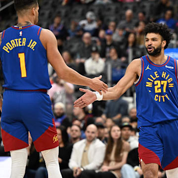 Feb 28, 2025; Detroit, Michigan, USA;  Denver Nuggets guard Jamal Murray (27) celebrates with forwards Michael Porter Jr. (1) and Zeke Nnaji (22) after scoring and drawing a foul against the Detroit Pistons in the first quarter at Little Caesars Arena. Mandatory Credit: Lon Horwedel-Imagn Images