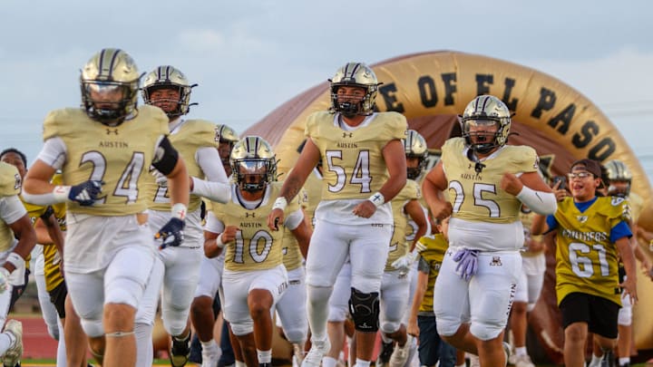 Austin High School’s football team runs out of the tunnel to face El Paso High for the Battle of the Claw rivalry game on Aug. 29, 2025, at Austin High School in El Paso, Texas.