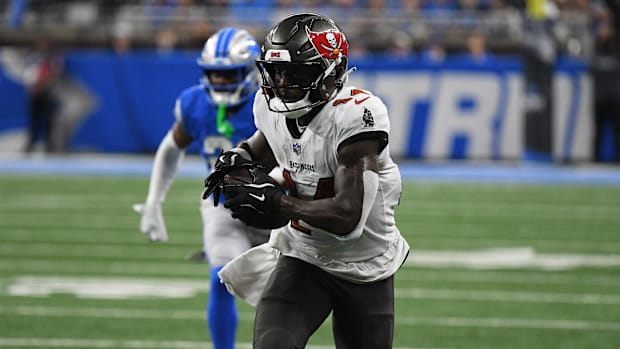 Tampa Bay Buccaneers star Chris Godwin is pictured running with the football.