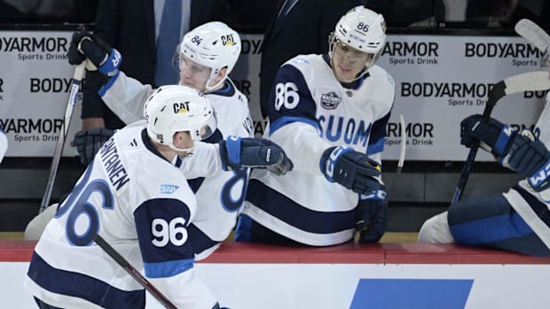 Hockey players celebrate a goal score