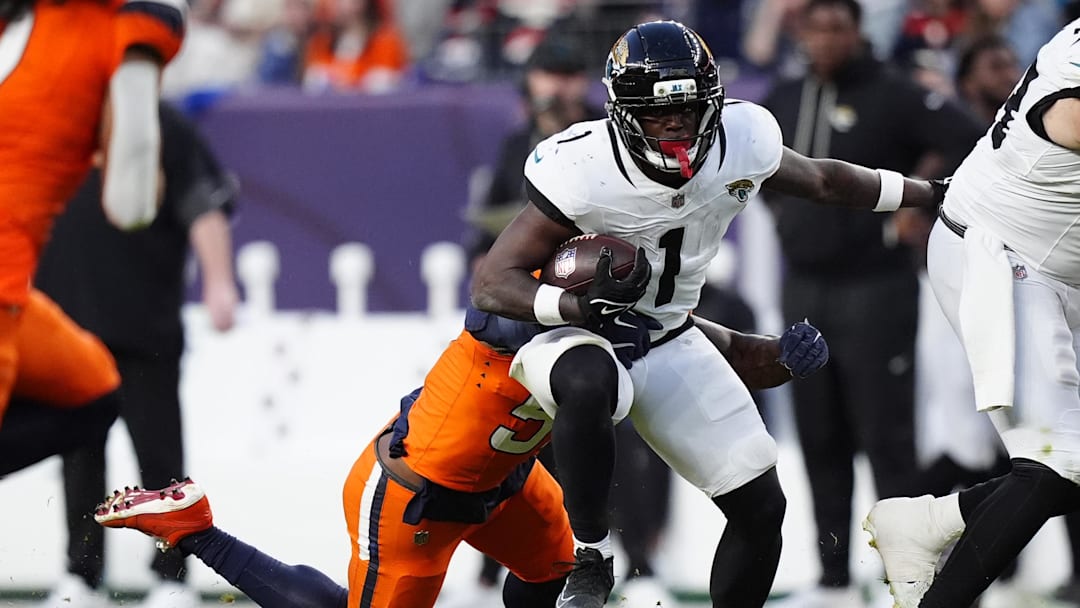 Dec 21, 2025; Denver, Colorado, USA; Jacksonville Jaguars running back Travis Etienne (1) rushes the ball against the Denver Broncos during the second half at Empower Field at Mile High. Mandatory Credit: Ron Chenoy-Imagn Images Dec 21, 2025; Denver, Colorado, USA; Jacksonville Jaguars running back Travis Etienne (1) rushes the ball against the Denver Broncos during the second half at Empower Field at Mile High. Mandatory Credit: Ron Chenoy-Imagn Images