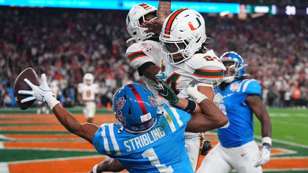 Jan 8, 2026; Glendale, AZ, USA; Mississippi Rebels wide receiver De'zhaun Stribling (1) attempts to make a catch against Miami  Hurricanes defensive back Ethan O'Connor (24) in the second half during the 2026 Fiesta Bowl and semifinal game of the College Football Playoff at State Farm Stadium. Mandatory Credit: Joe Camporeale-Imagn Images