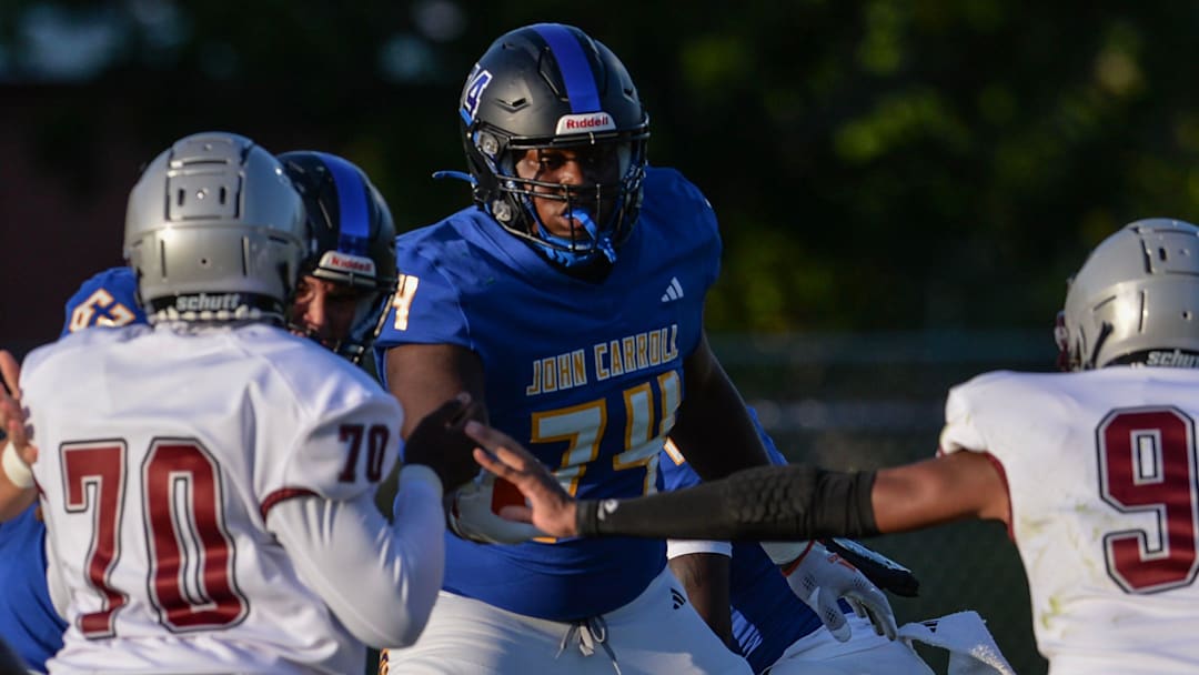 John Carroll's Sean Tatum (74) helps block Palm Beach Lakes defenders during their game at John Carroll High School on Friday, Aug. 16, 2024, in Fort Pierce.