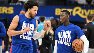 Feb 9, 2025; Detroit, Michigan, USA; Detroit Pistons guard Cade Cunningham (2) talks to newly acquired Pistons guard, Dennis Schroder (right):  Lon Horwedel-Imagn Images