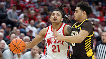 Dec 17, 2024; Columbus, Ohio, USA;  Ohio State Buckeyes forward Devin Royal (21) dribbles past Valparaiso Beacons forward Devon Ellis (11) during the second half at Value City Arena.