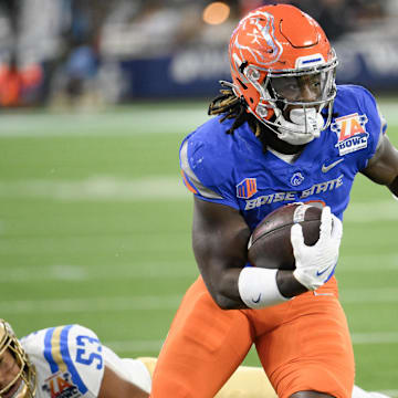 Dec 16, 2023; Inglewood, CA, USA; Boise State Broncos running back Ashton Jeanty (2) slips a tackle by UCLA Bruins linebacker Darius Muasau (53) during the first quarter of the Starco Brands LA Bowl at SoFi Stadium.