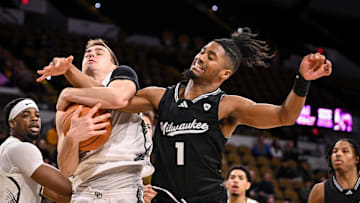 Oakland Golden Grizzlies guard Jayson Woodrich (11) grabs a rebound over UW-Milwaukee Panthers guard Themus Fulks (1) during the second half in a game Thursday, February 27, 2025, at the UWM Panther Arena in Milwaukee, Wisconsin. UWM won, 71-66.