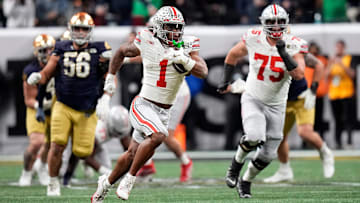Ohio State Buckeyes running back Quinshon Judkins (1) gets away from the Notre Dame Fighting Irish defense for a long run in the third quarter during the College Football Playoff championship at Mercedes-Benz Stadium in Atlanta on January 20, 2025.