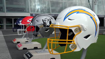Large helmets of the Los Angeles Chargers, Las Vegas Raiders, Kansas City Chiefs and Denver Broncos of the AFC West before an NFL International Series game at Tottenham Hotspur Stadium. 