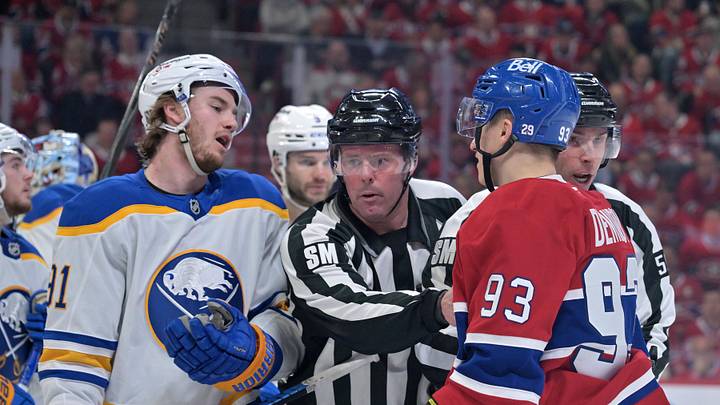 May 12, 2026; Montreal, Quebec, CAN; linesmen Julien Fournier (56) and Matt MacPherson (83) step in between Buffalo Sabres forward Josh Doan (91) and Montreal Canadiens forward Ivan Demidov (93) during the third period in game four of the second round of the 2026 Stanley Cup Playoffs at Bell Centre. Mandatory Credit: Eric Bolte-Imagn Images