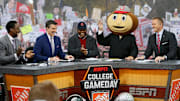 Lee Corso waves while wearing a Brutus Buckeye head during an episode of "College GameDay" in 2015.