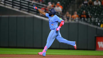 Jul 29, 2024; Baltimore, Maryland, USA; Toronto Blue Jays first baseman Vladimir Guerrero Jr. (27) hits a home run during the eighth inning against the Baltimore Orioles at Oriole Park at Camden Yards. Mandatory Credit: Reggie Hildred-USA TODAY Sports