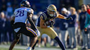 Nov 18, 2023; Annapolis, Maryland, USA; Navy Midshipmen wide receiver Regis Velez (84) runs the ball against East Carolina Pirates defensive back Shavon Revel (28) during the second quarter at Navy-Marine Corps Memorial Stadium. Mandatory Credit: Reggie Hildred-Imagn Images
