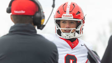 East Kentwood's Kayd Coffman talks to the coaching staff during a 49-41 victory over Howell in the district finals at Howell High School, Saturday, Nov. 8, 2025.
