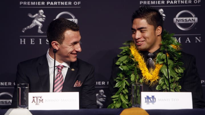 Dec 8, 2012; New York, NY, USA; Texas A&M Aggies quarterback Johnny Manziel (left) laughs with Notre Dame Fighting Irish linebacker Manti Te'o during a press conference before the announcement of the 2012 Heisman Trophy winner at the Marriott Marquis in downtown New York City.  