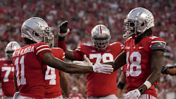 Sep 17, 2022; Columbus, Ohio, USA; Ohio State Buckeyes wide receiver Jaxon Smith-Njigba (11) celebrates with Ohio State Buckeyes wide receiver Marvin Harrison Jr. (18) celebrate Harrison Jr. scored a touchdown during a college football game against the Toledo Rockets at Ohio Stadium. Mandatory Credit: Barbara Perenic-Imagn Images
