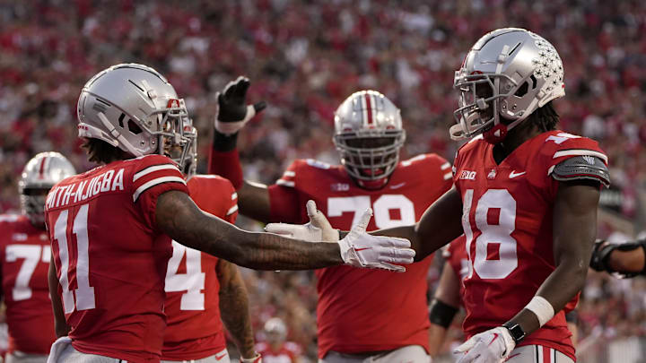 Sep 17, 2022; Columbus, Ohio, USA; Ohio State Buckeyes wide receiver Jaxon Smith-Njigba (11) celebrates with Ohio State Buckeyes wide receiver Marvin Harrison Jr. (18) celebrate Harrison Jr. scored a touchdown during a college football game against the Toledo Rockets at Ohio Stadium. Mandatory Credit: Barbara Perenic-Imagn Images