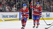 Jan 6, 2025; Montreal, Quebec, CAN; Montreal Canadiens forward Cole Caufield (13) celebrates the win against the Vancouver Canucks with teammate forward Alex Newhook (15) at the Bell Centre. Mandatory Credit: Eric Bolte-Imagn Images