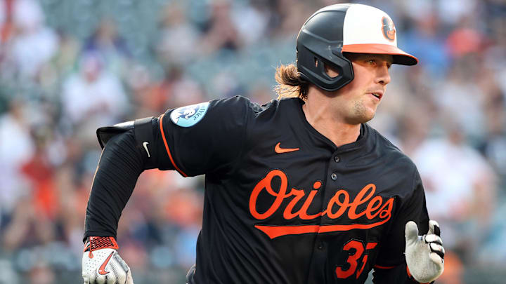 Jun 11, 2025; Baltimore, Maryland, USA; Baltimore Orioles catcher Adley Rutschman (35) hits a single during the fifth inning against the Detroit Tigers at Oriole Park at Camden Yards.