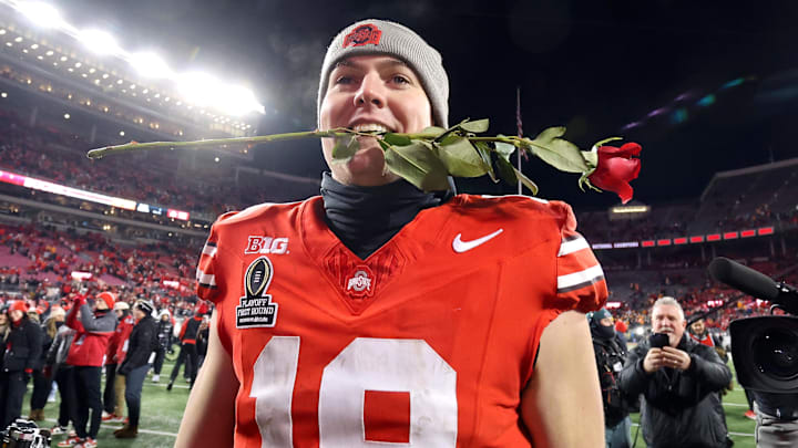 Dec 21, 2024; Columbus, Ohio, USA; Ohio State Buckeyes quarterback Will Howard (18) celebrates the win as he carries a rose after the game against the Tennessee Volunteers at Ohio Stadium. Mandatory Credit: Joseph Maiorana-Imagn Images Dec 21, 2024; Columbus, Ohio, USA; Ohio State Buckeyes quarterback Will Howard (18) celebrates the win as he carries a rose after the game against the Tennessee Volunteers at Ohio Stadium. Mandatory Credit: Joseph Maiorana-Imagn Images