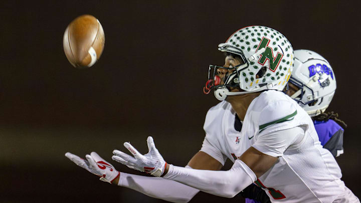 Lawrence North High School sophomore Monshun Sales (1) makes a reception for a 38-yard gain during the first half of an IHSAA Class 6A Regional Championship game against Brownsburg High School, Friday, Nov. 15, 2024, at Brownsburg High School.