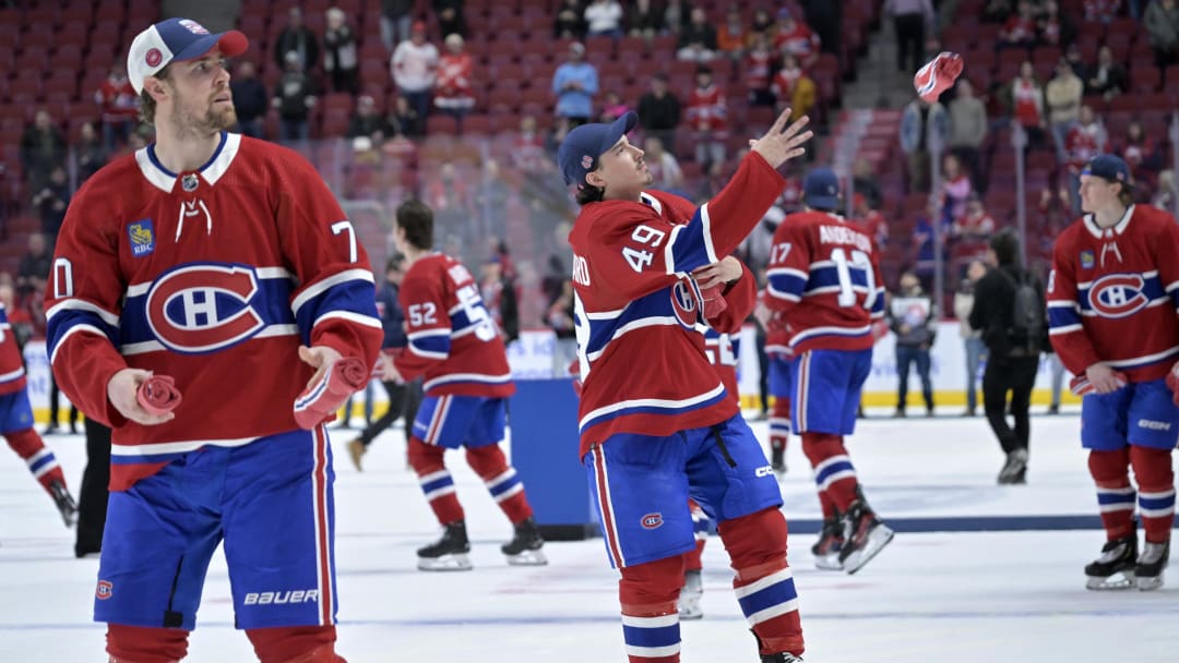 Apr 16, 2024; Montreal, Quebec, CAN; Montreal Canadiens forward Tanner Pearson (70) and teammates including forward Rafael Harvey-Pinard (49) throw souvenirs to fans after a game against the Detroit Red Wings at the Bell Centre. Mandatory Credit: Eric Bolte-USA TODAY Sports