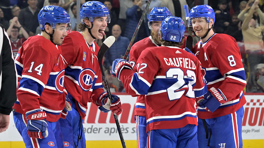 Apr 9, 2024; Montreal, Quebec, CAN; Montreal Canadiens forward Juraj Slafkovsky (20) celebrates with teammates including defenseman Mike Matheson (8) and Montreal Canadiens forward Nick Suzuki (14) and  forward Cole Caufield (22) after scoring a goal against the Philadelphia Flyers during the second period at the Bell Centre. Mandatory Credit: Eric Bolte-Imagn Images